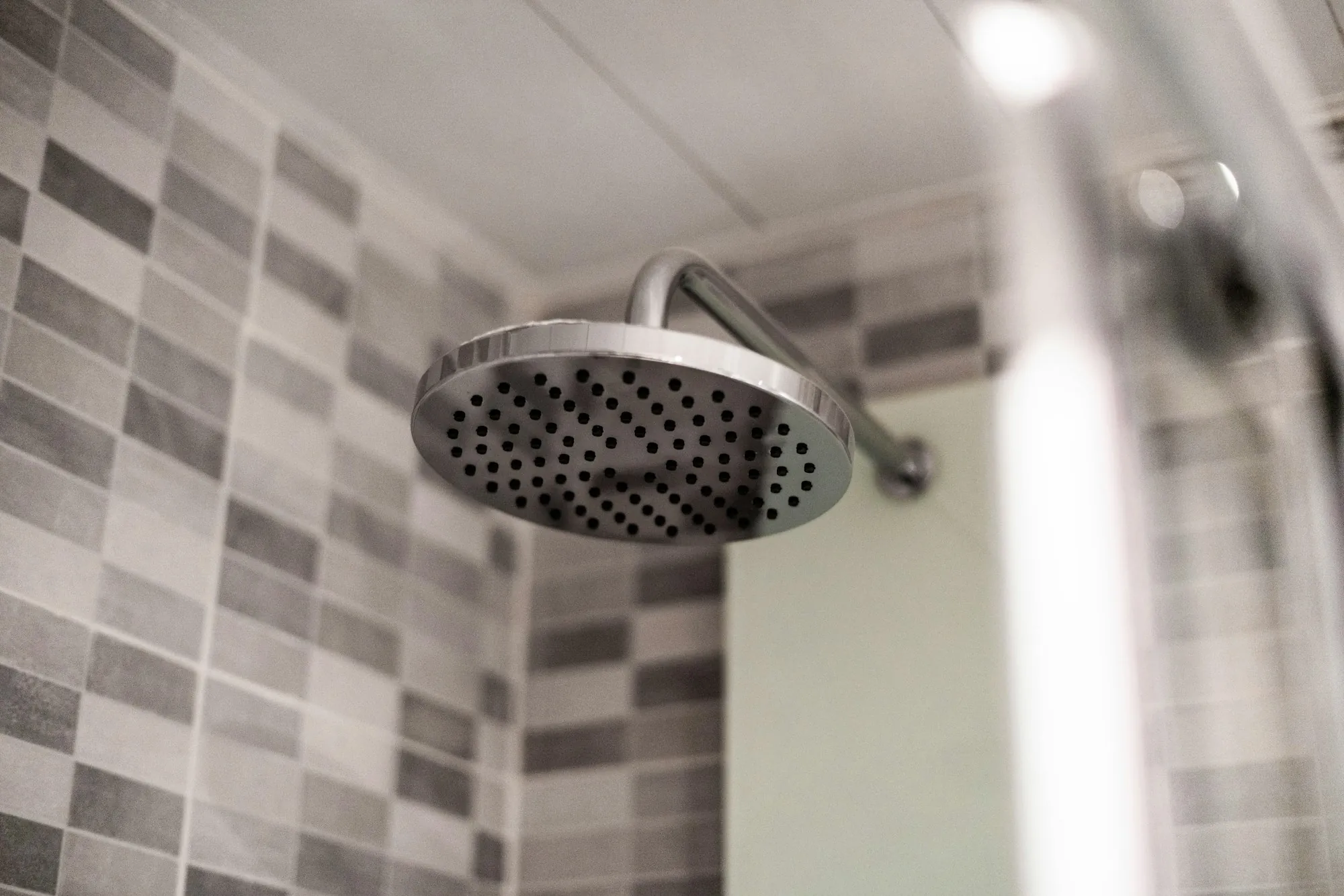 Rain shower head against gray tile