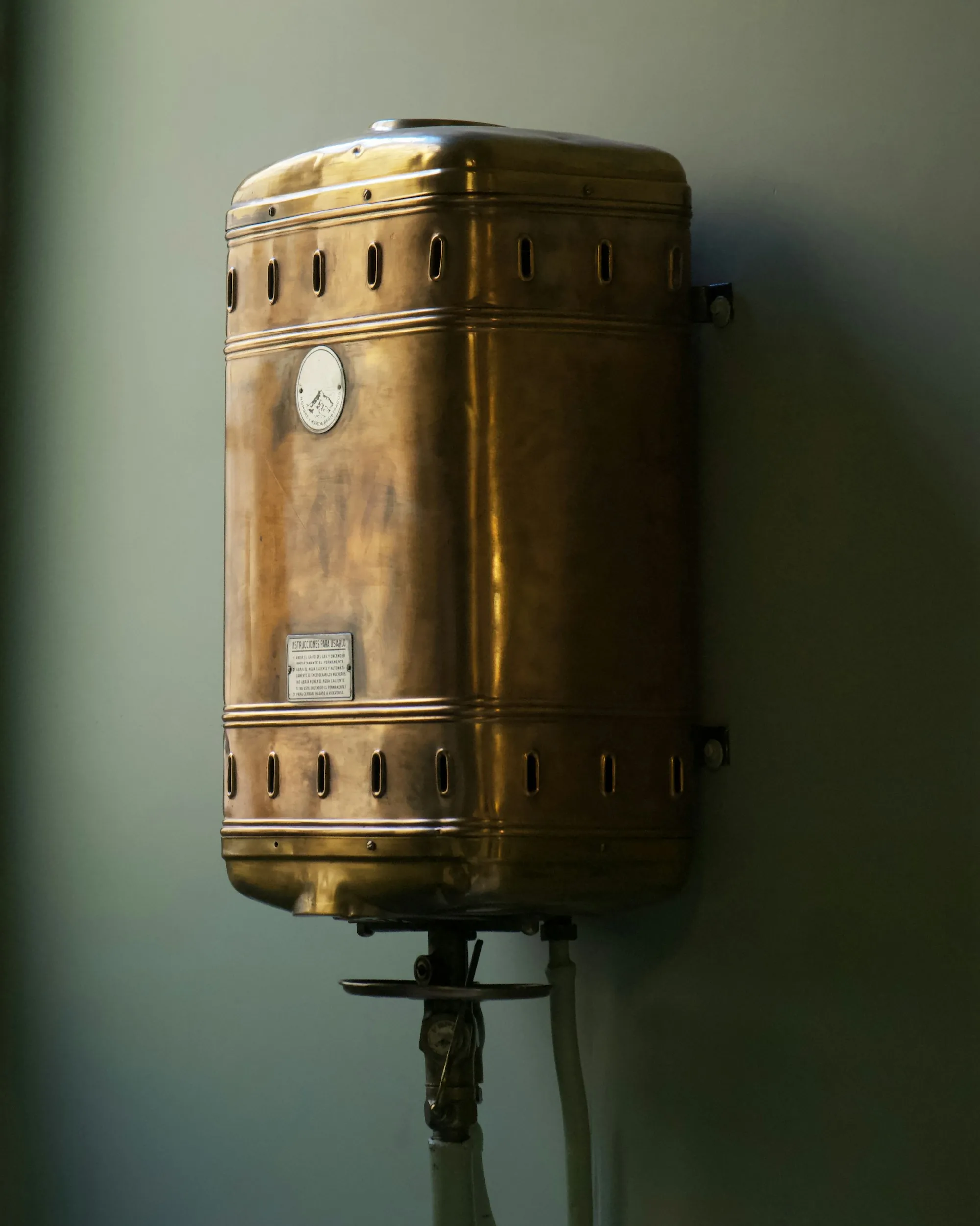 Older water heater mounted on a wall