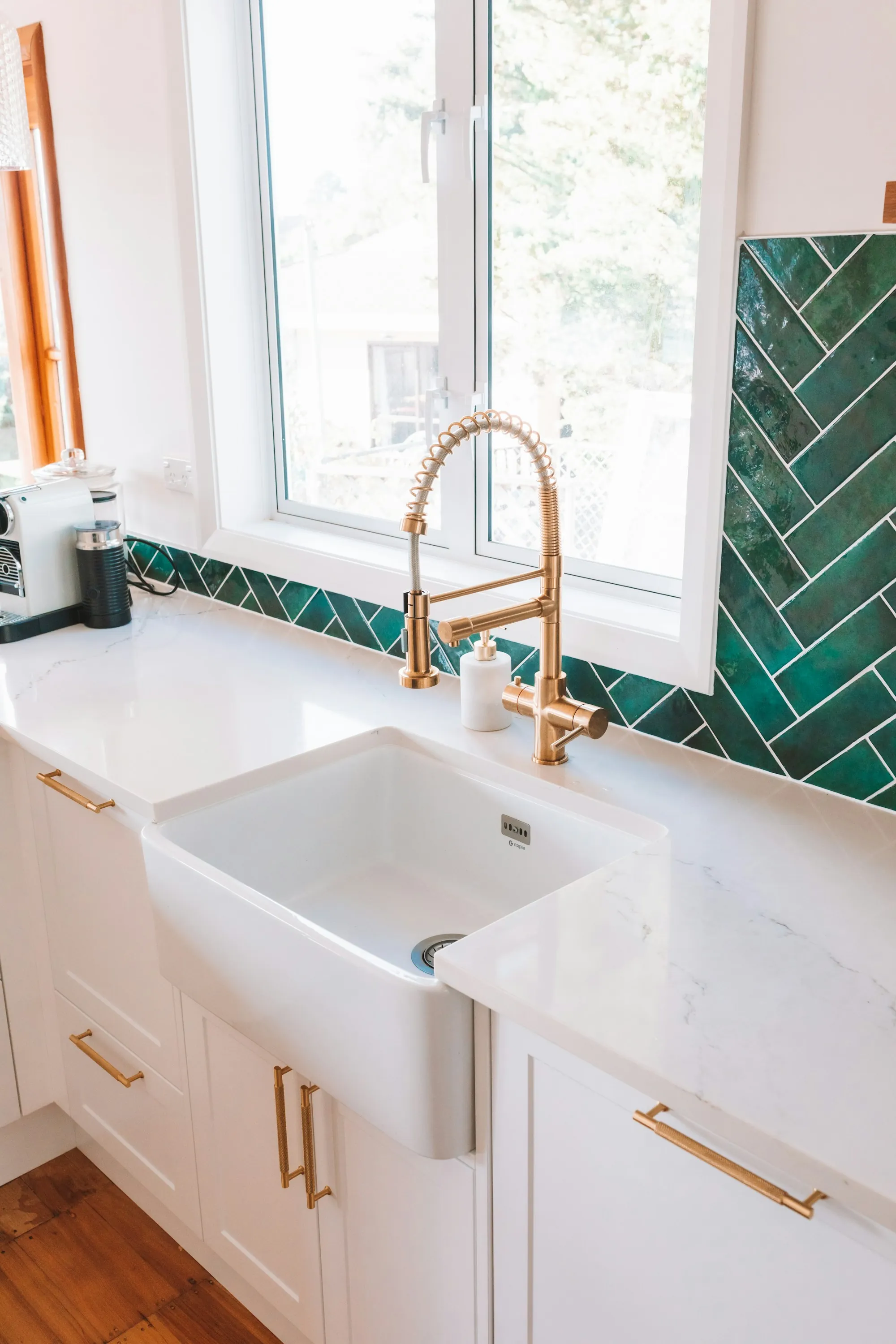 Bright kitchen sink with a brass faucet