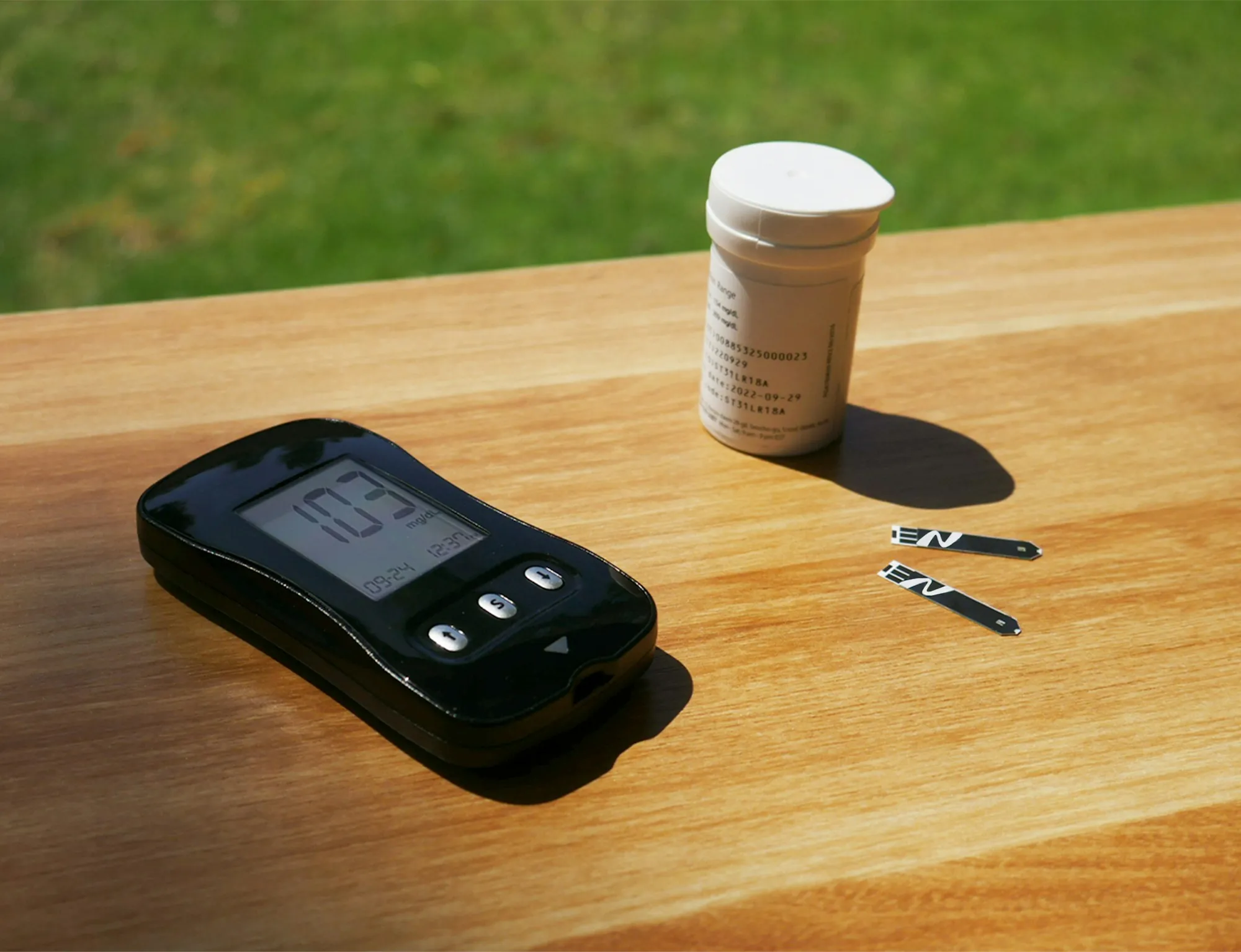 Handheld water test meter on a wooden table