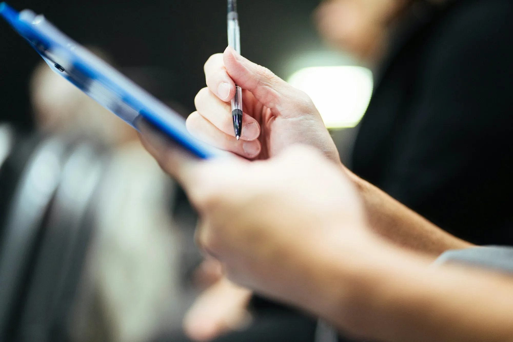 Technician recording water test results on a clipboard