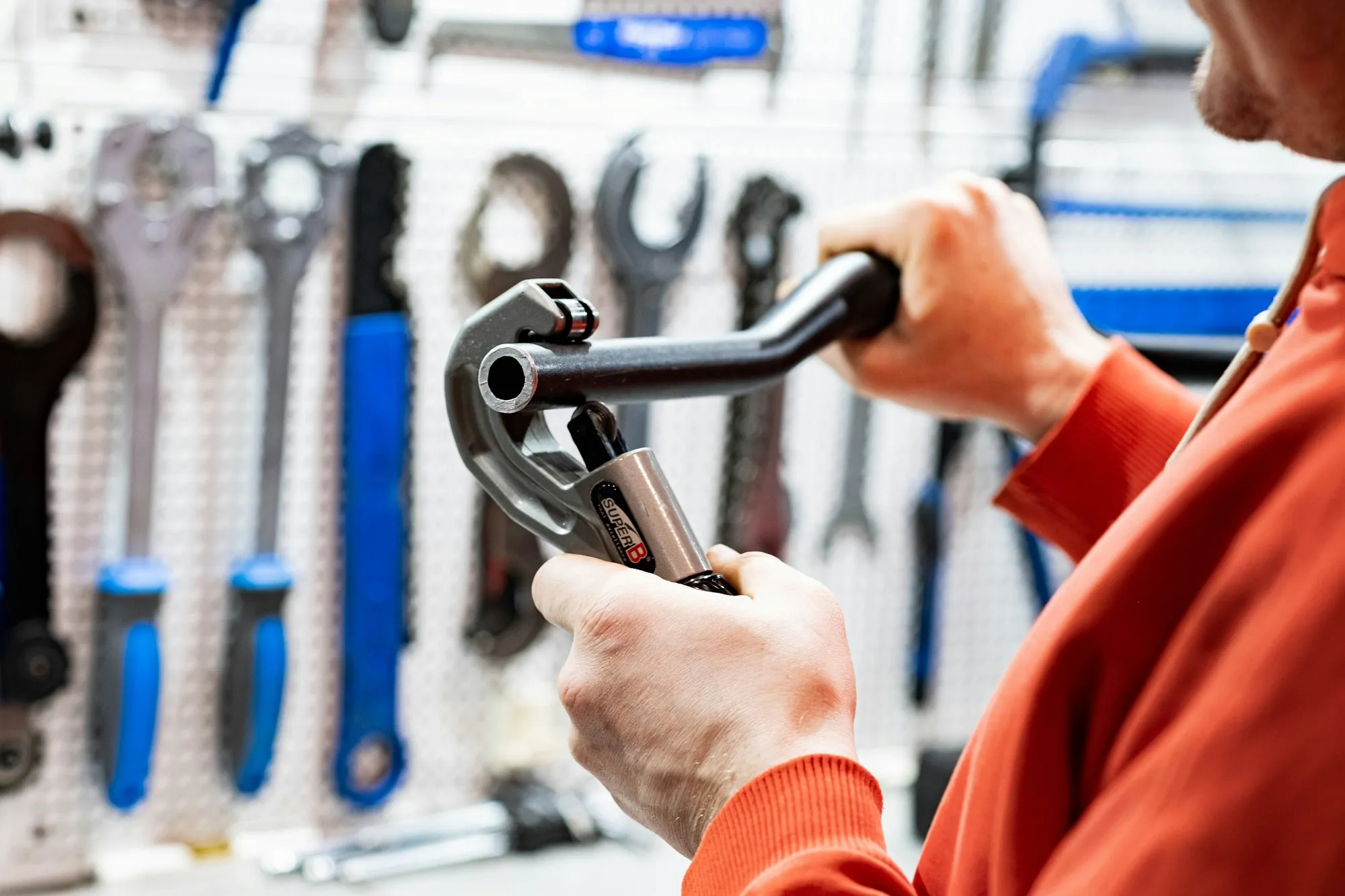 Technician tightening a fitting with a wrench